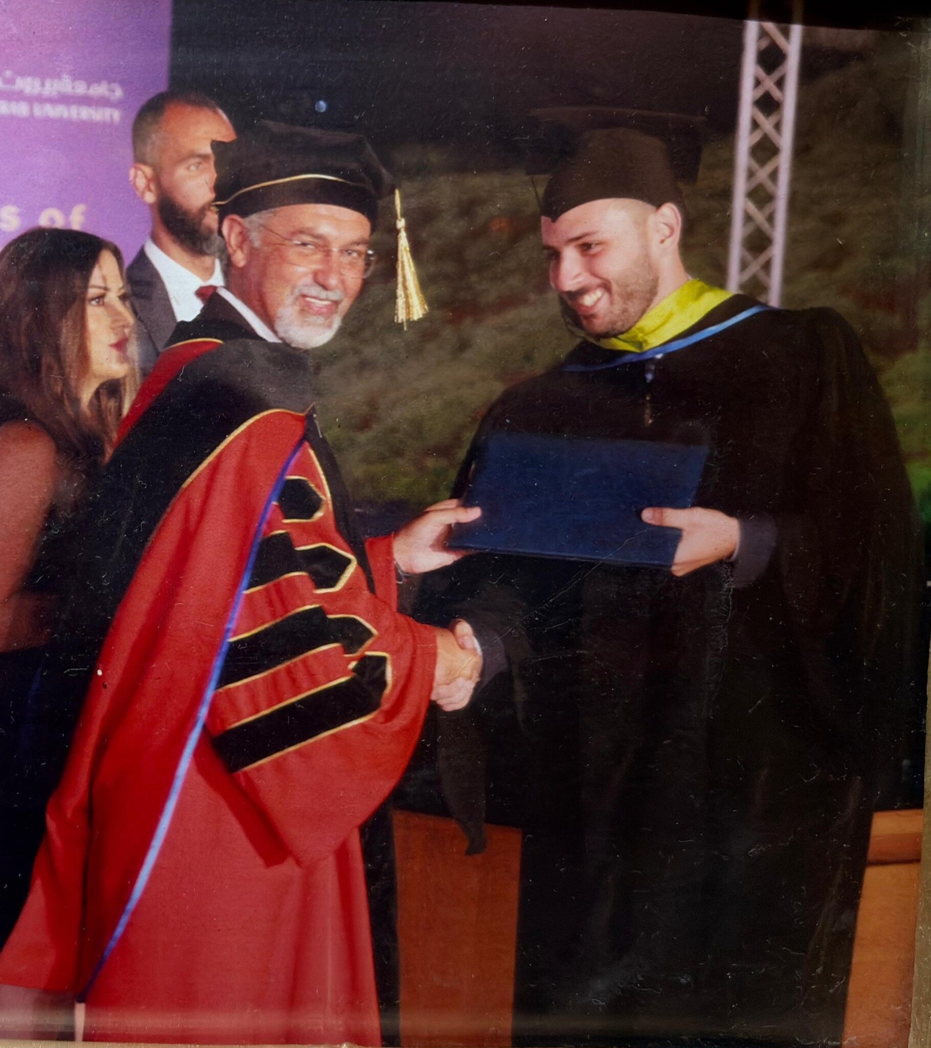 HHS III alumnus receiving a university diploma